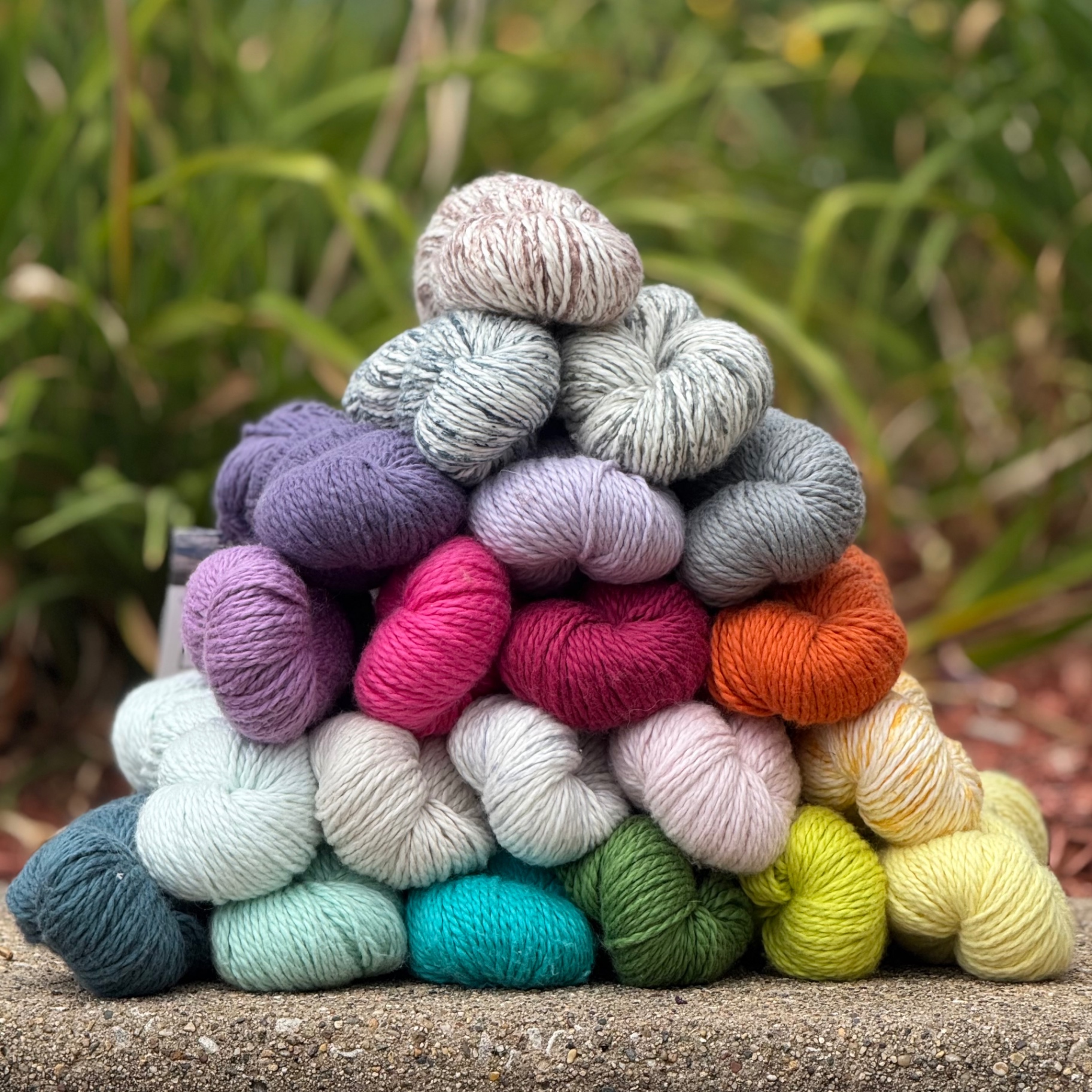 A rainbow stack of worsted-weight yarn at the shop